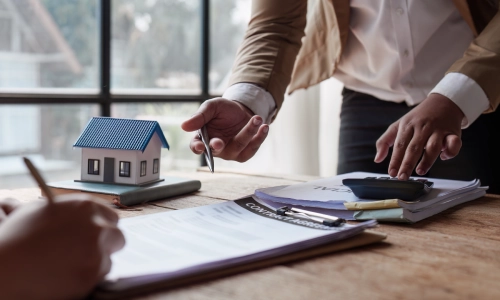 A lawyer is discussing an important case with another man who is taking notes during their discussion.