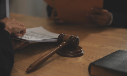 A New York Contract Lawyer discussing with a client while sitting on opposite sides of an office table.