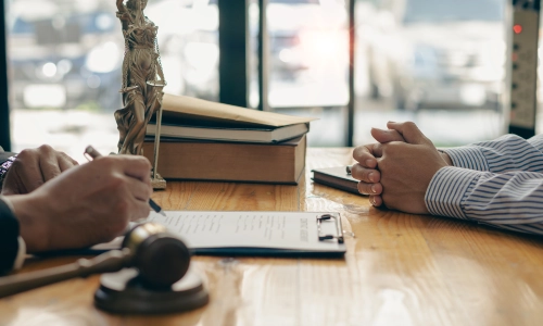 A commercial truck accident attorney negotiating with an insurance adjuster regarding the settlement offer for his client’s claim.